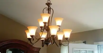 Classic ceiling chandelier installation with warm lighting in Orlando, FL