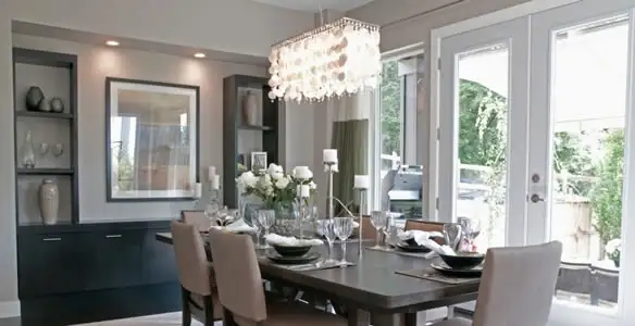 Elegant dining room chandelier installation above table in Orlando, FL