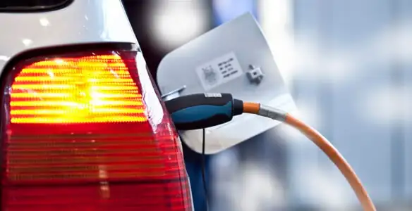 Electric car plugged into EV charger after professional installation in Orlando, FL