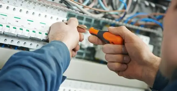 electrical service showing licensed electrician performing electrical panel maintenance and adjustments in Orlando, FL