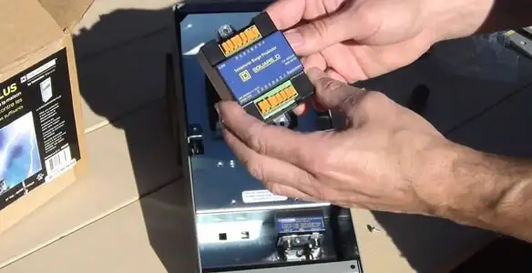Electrician installing whole home surge protection unit inside main electrical panel in Orlando, FL