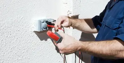 Electrician performing home electrical outlet and wiring inspection in Orlando, FL