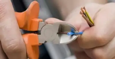 professional electrical services showing precise wire cutting by licensed electricians in Orlando, FL