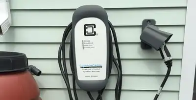 Outdoor electric vehicle charger installation on residential wall in Orlando, FL