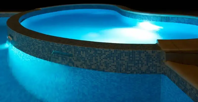 pool light installation and repair services highlighting illuminated pool interior lighting in Orlando, FL