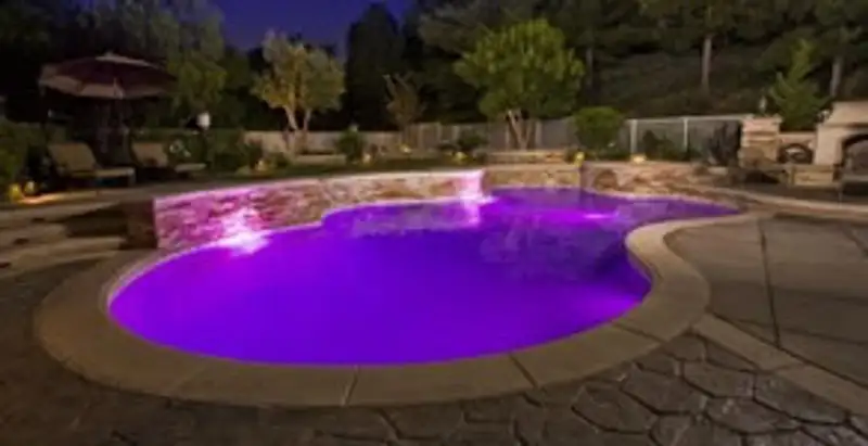pool light installation and repair services illuminating a residential swimming pool in Orlando, FL